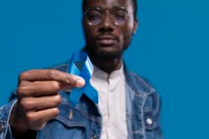 african american man holding blue ribbon